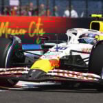 A Formula 1 race car drives in front of a sign reading Mexico City