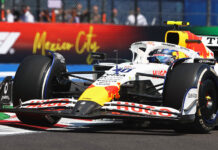 A Formula 1 race car drives in front of a sign reading Mexico City