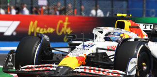 A Formula 1 race car drives in front of a sign reading Mexico City