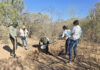 A group of women and a man from Buscadoras Por La Paz in Hermosillo dig a whole in the desert
