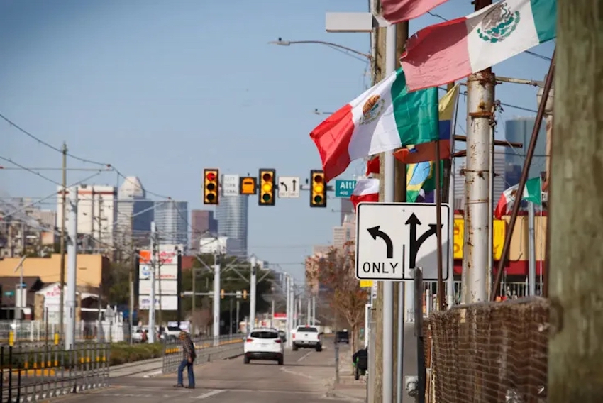 Mexican flags flying on a Texas roadside.