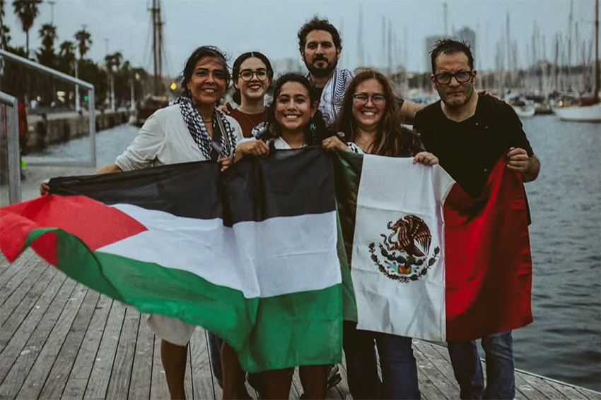 Six Mexicans pose with a Palestine and Mexican flag