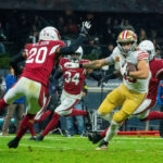 American football players in red and yellow jerseys