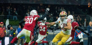 American football players in red and yellow jerseys