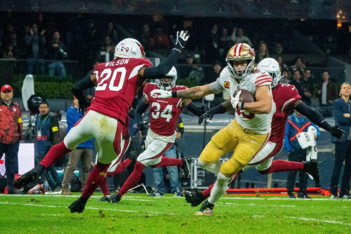 American football players in red and yellow jerseys