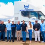 staff in front of electric transport vehicle