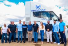 staff in front of electric transport vehicle