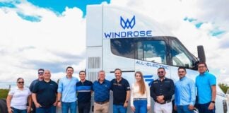 staff in front of electric transport vehicle