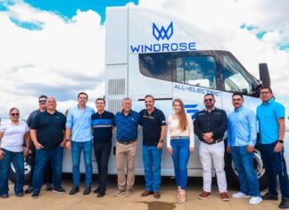 staff in front of electric transport vehicle