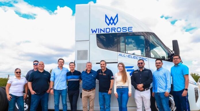 staff in front of electric transport vehicle