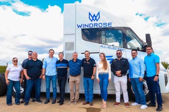staff in front of electric transport vehicle