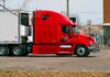 a side view of a red heavy duty truck