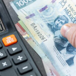 Stock image of a 500 Mexican peso bill next to a calculator