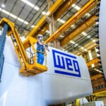 Brazilian manufacturer, facing 50% US tariffs, looks to invest in Mexico An engineer in a forklift next to a piece of machinery labeled WEG
