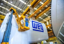 Brazilian manufacturer, facing 50% US tariffs, looks to invest in Mexico An engineer in a forklift next to a piece of machinery labeled WEG