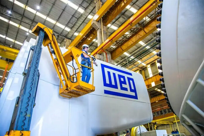 An engineer in a forklift next to a piece of machinery labeled WEG
