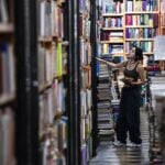 a girl looks at shelves in a book store