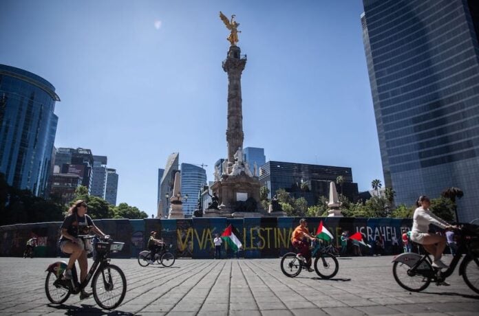 Cyclists enjoy a car-free Paseo Dominical along Reforma Avenue in Mexico City.