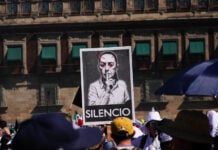 Protest sign with the word "SILENCIO" and a modified photo of Mexican President Claudia Sheinbaum on a poster at a "Generation X" protest near Mexico City's National Palace in November 2025, a sign of the political polarization currently heightening in Mexico.