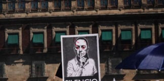 Protest sign with the word "SILENCIO" and a modified photo of Mexican President Claudia Sheinbaum on a poster at a "Generation X" protest near Mexico City's National Palace in November 2025, a sign of the political polarization currently heightening in Mexico.