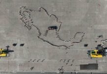 Aerial view of the line-up before the start of the parade and civic-military ceremony marking the 115th anniversary of the start of the Mexican Revolution in the Zócalo square.