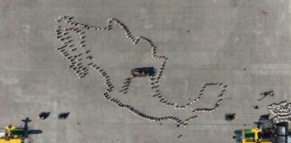 Aerial view of the line-up before the start of the parade and civic-military ceremony marking the 115th anniversary of the start of the Mexican Revolution in the Zócalo square.