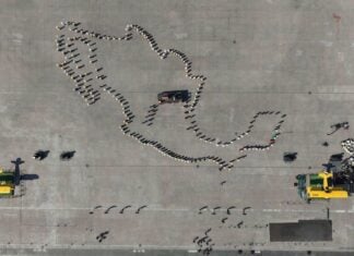 Aerial view of the line-up before the start of the parade and civic-military ceremony marking the 115th anniversary of the start of the Mexican Revolution in the Zócalo square.