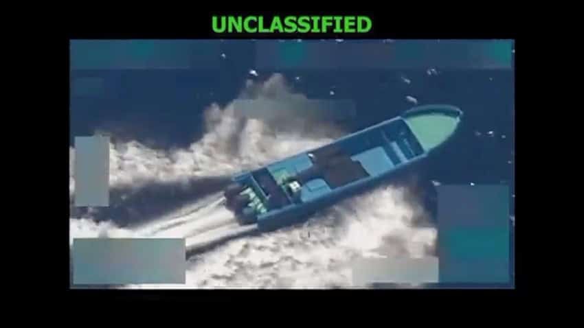 An aerial surveillance image shows a motor boat in the ocean with the word unclassified