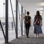 two women walking down a plane vestibule