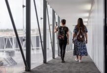 two women walking down a plane vestibule