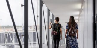 two women walking down a plane vestibule
