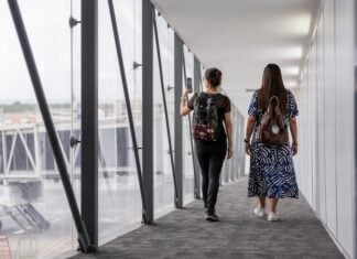two women walking down a plane vestibule