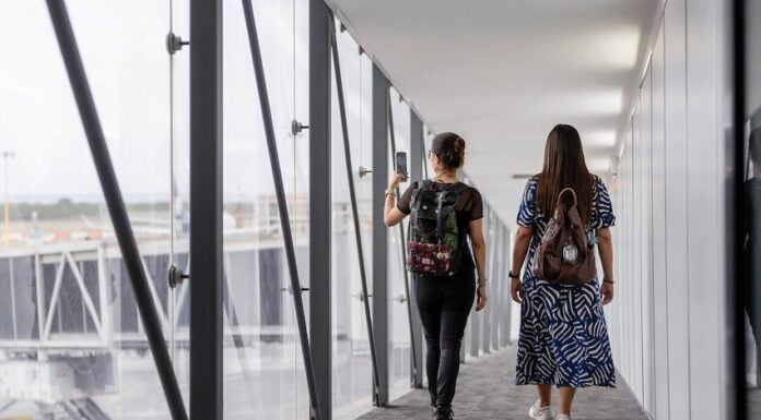 two women walking down a plane vestibule