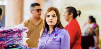 Grecia Quiroz in a purple shirt with the words DIF