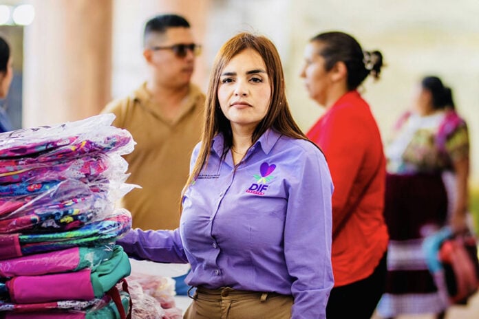 Grecia Quiroz in a purple shirt with the words DIF