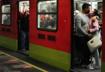A couple kisses through face masks on the Mexico City Metro