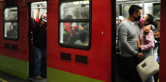 A couple kisses through face masks on the Mexico City Metro