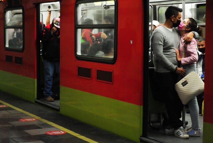A couple kisses through face masks on the Mexico City Metro