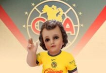 A baby Jesus doll dressed in a Club America soccer uniform