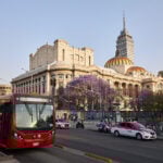 The Palace of Bellas Artes in Mexico City's historic center with a taxi and metrobus