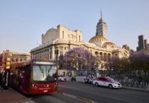 The Palace of Bellas Artes in Mexico City's historic center with a taxi and metrobus