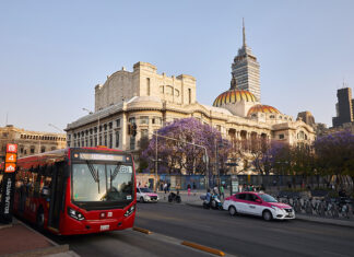The Palace of Bellas Artes in Mexico City's historic center with a taxi and metrobus
