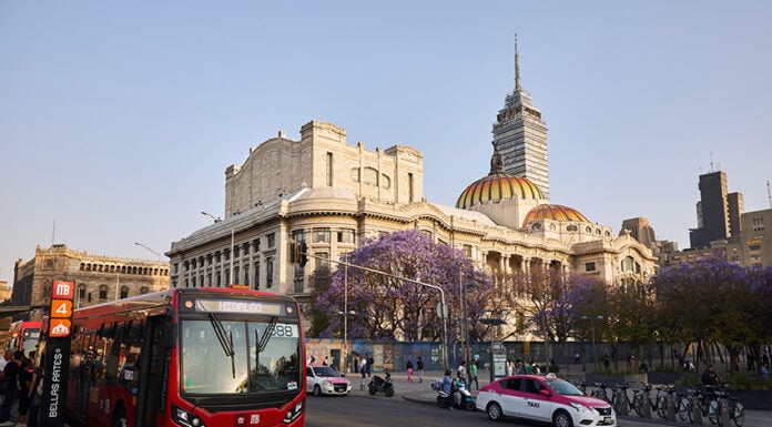 The Palace of Bellas Artes in Mexico City's historic center with a taxi and metrobus