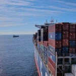 A cargo ship heads out to sea, leaving the Mexican port of Manzanillo