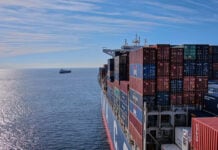 A cargo ship heads out to sea, leaving the Mexican port of Manzanillo