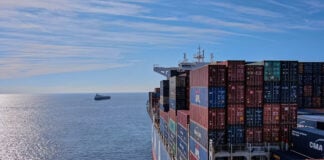 A cargo ship heads out to sea, leaving the Mexican port of Manzanillo