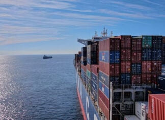 A cargo ship heads out to sea, leaving the Mexican port of Manzanillo