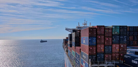 A cargo ship heads out to sea, leaving the Mexican port of Manzanillo