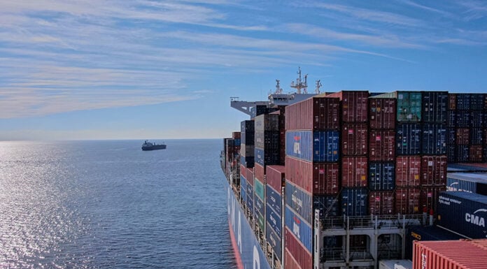 A cargo ship heads out to sea, leaving the Mexican port of Manzanillo