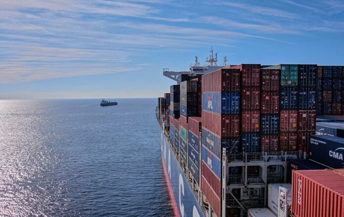 A cargo ship heads out to sea, leaving the Mexican port of Manzanillo